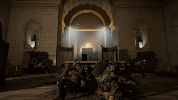 A screenshot of Tom Clancy's Division 2 that depicts the founding documents' gallery. The reviewer's avatar is crouched behind cover in the middle of the room.